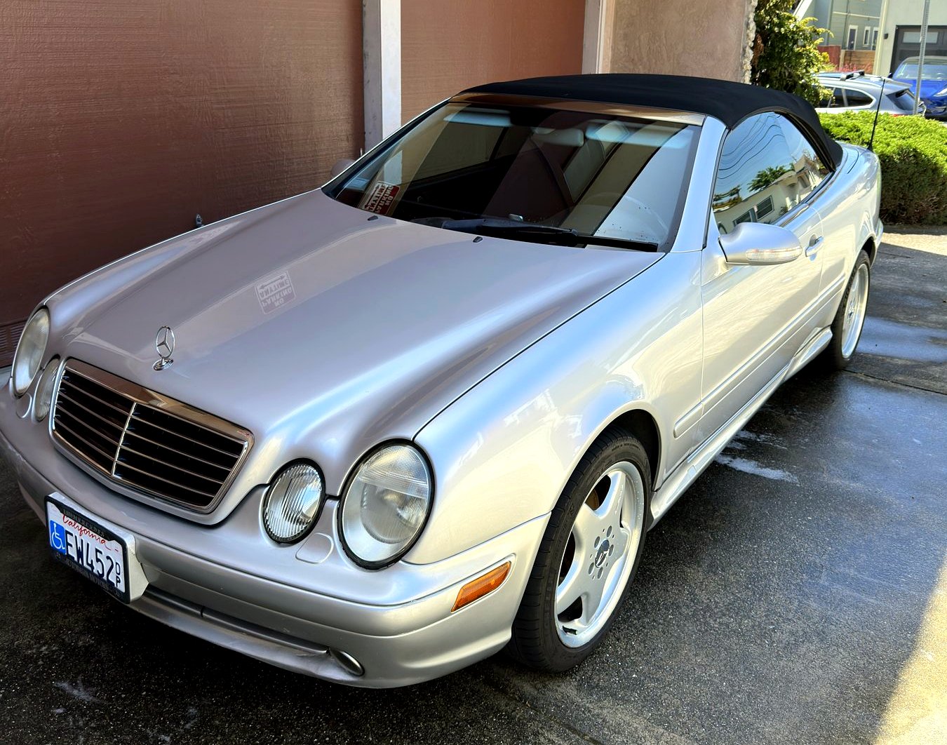 Silver Mercedes CLK reflecting the sky